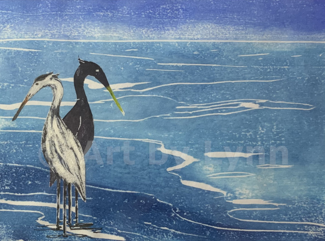 Woodcut print of two crains by the sea.